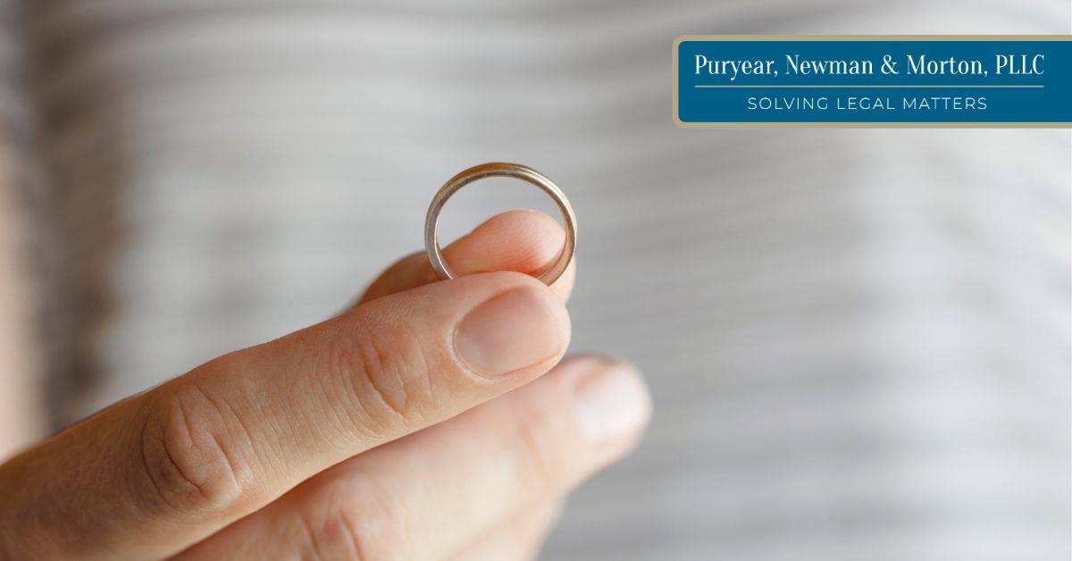 Woman's fingers holding a wedding ring